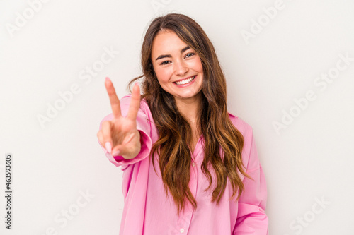 Wallpaper Mural Young caucasian woman isolated on white background joyful and carefree showing a peace symbol with fingers. Torontodigital.ca