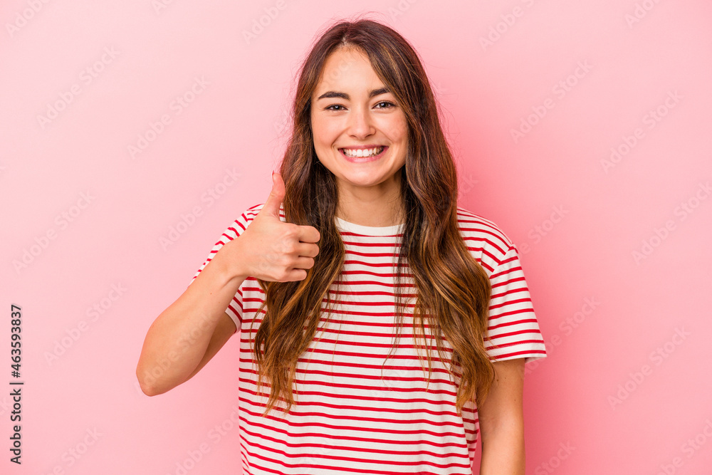 Young caucasian woman isolated on pink background smiling and raising thumb up Young caucasian woman isolated on pink background smiling and raising thumb up