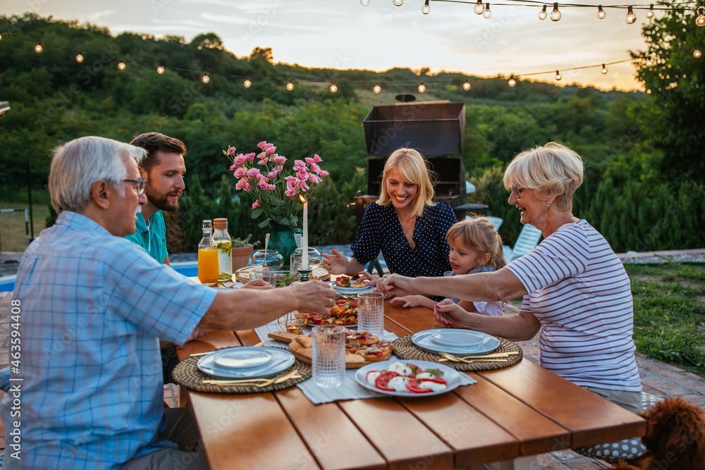 Affectionate family enjoying dinner during their get together in the ...