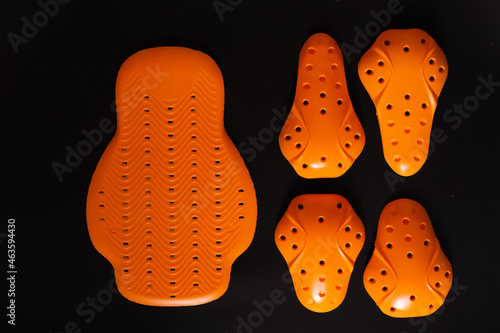 Moto-protection.  Protective inserts for the back, knees, elbows, shoulders and hips against a dark background