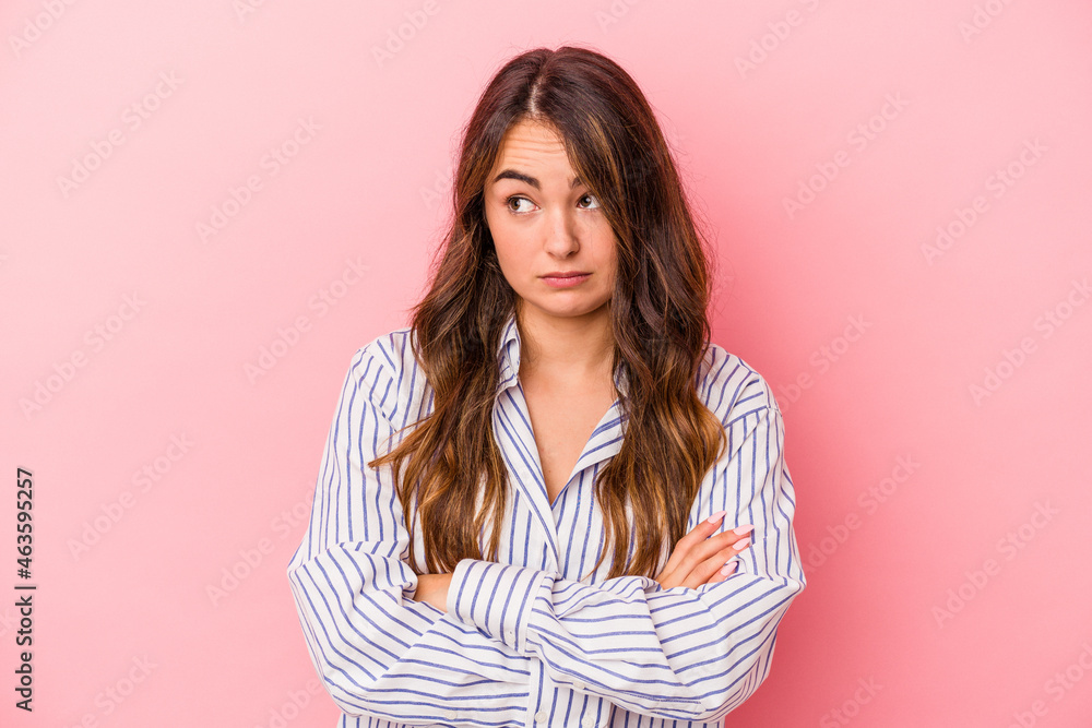 Young caucasian woman isolated on pink background tired of a repetitive task. Young caucasian woman isolated on pink background tired of a repetitive task.