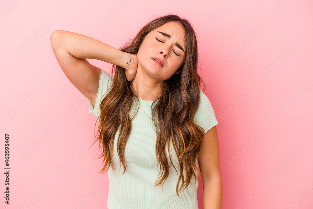 Young caucasian woman isolated on pink background massaging elbow, suffering after a bad movement. Young caucasian woman isolated on pink background massaging elbow, suffering after a bad movement.