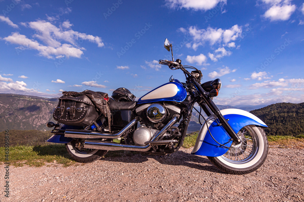 Retro cruiser motorcycle parked at side of mountain road in South tyrol; nostalgic look of the indian classic style Retro cruiser motorcycle parked at side of mountain road in South tyrol; nostalgic look of the indian classic style