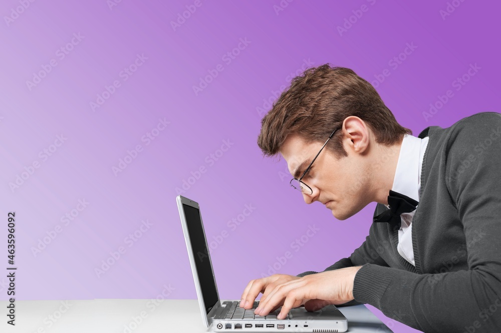 Man using a laptop against color background Man using a laptop against color background