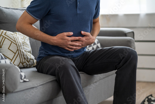 Stomach ache  man with abdominal pain suffering at home