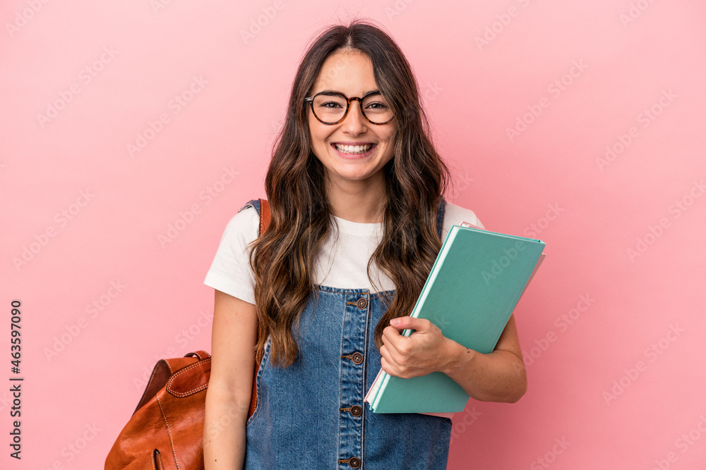 Young caucasian student woman isolated on pink background laughing and having fun. - obrazy, fototapety, plakaty 
