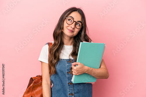 Tableau sur toile Young caucasian student woman isolated on pink background dreaming of achieving