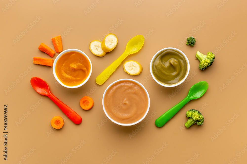 Feeding baby with fruits puree. Natural organic baby food Feeding baby with fruits puree. Natural organic baby food