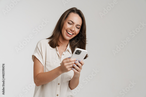 Young brunette woman smiling while posing with credit card