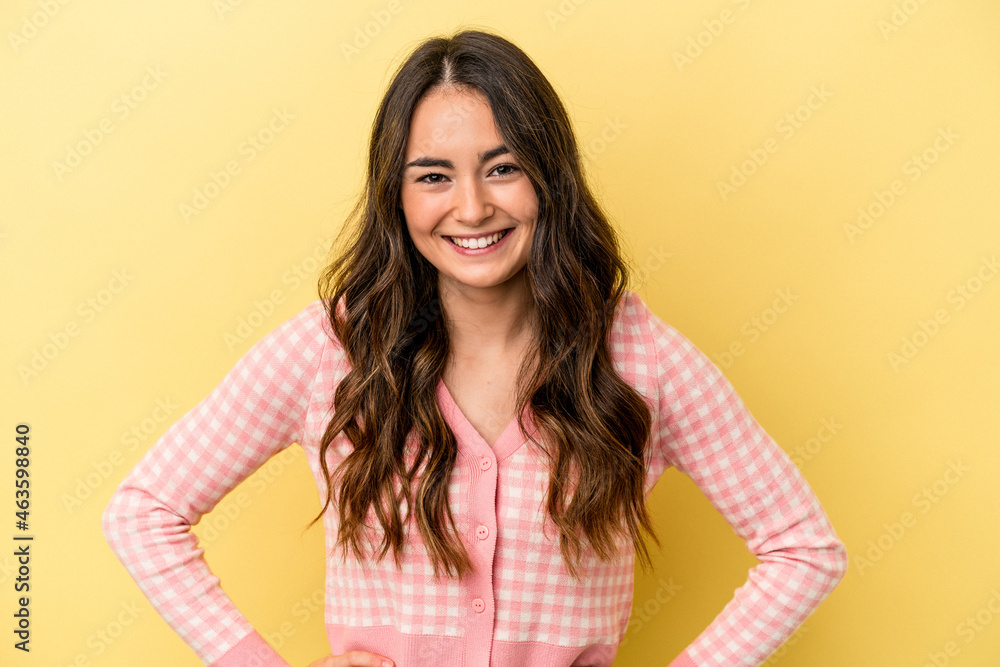 Young caucasian woman isolated on yellow background confident keeping hands on hips. Young caucasian woman isolated on yellow background confident keeping hands on hips.