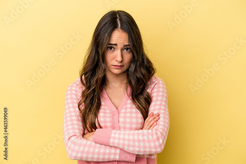 Young caucasian woman isolated on yellow background unhappy looking in camera with sarcastic expression. © Asier