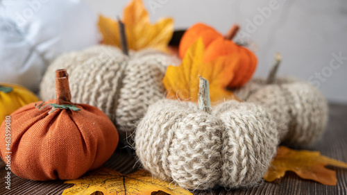 Photography Hand made fabric pumpkin over grey knitted blanket for fall home decoration
