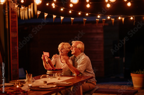 Senior caucasian couple on video call celebrating birthday