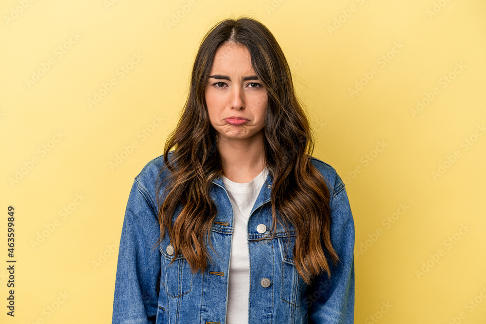 Fototapeta premium Young caucasian woman isolated on yellow background sad, serious face, feeling miserable and displeased.