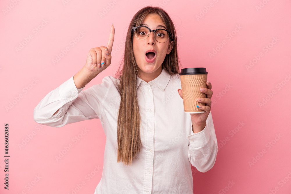 Young business caucasian woman holding a take away isolated on pink background having an idea, inspiration concept. Young business caucasian woman holding a take away isolated on pink background having an idea, inspiration concept.