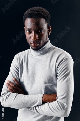 handsome man african appearance look ahead dark background