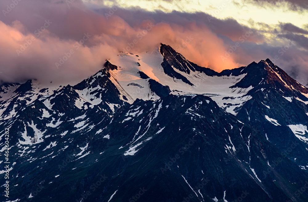 Dramatic orange clouds over the  Wilder Freiger mountain in austrian Stubai Alps.