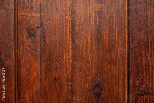 Wooden plank with saw marks and dark knots varnished in a reddish tone. Vector wood texture background