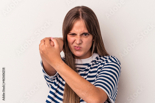 Young caucasian woman isolated on white background having a neck pain due to stress, massaging and touching it with hand. © Asier