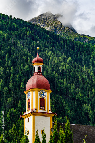 A peak of mountain Habicht in austrian Stubai Alps with the local church in foreground.  photo