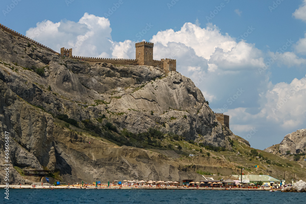 View from the sea on the wall and towers of the Genoese fortress on the rock. Fortress in Sudak.