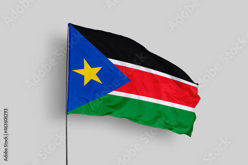Free Download South Sudan flag isolated on the blue sky background. close up waving flag of South Sudan. flag symbols of South Sudan. Concept of South Sudan. - GFXLoad