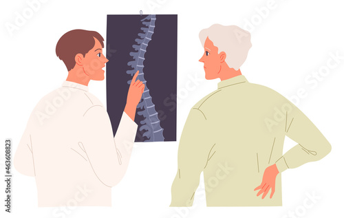 Doctor examines the image of the patients spine