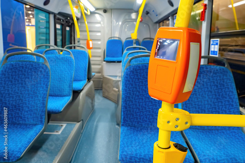 Bus validator for travel tickets. System of automated payment acceptance. Contactless payment on bus. Validator for NFC payment on bus. NFC pay in public transport. Autobus interior