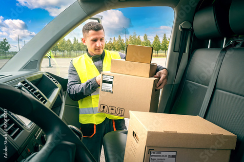 Courier with cardboard boxe...