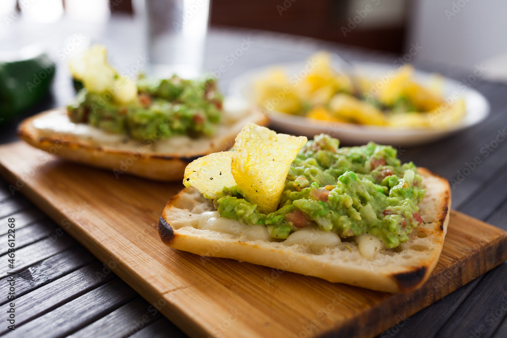 toasted slices of square bread with warm cheese and homemade guacamole on plate for healthy breakfast toasted slices of square bread with warm cheese and homemade guacamole on plate for healthy breakfast