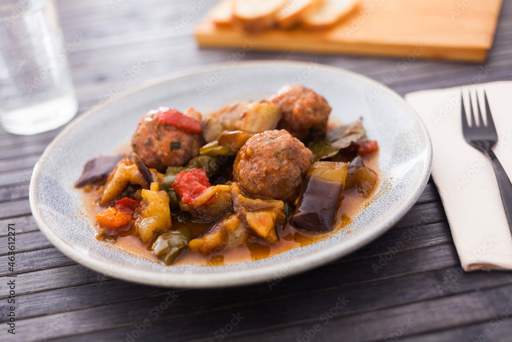 baked meatballs with stewed eggplant, zucchini, green peppers and tomatoes with haze in bowl baked meatballs with stewed eggplant, zucchini, green peppers and tomatoes with haze in bowl
