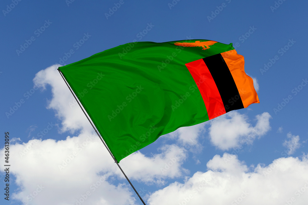 Zambia flag isolated on the blue sky background. close up waving flag