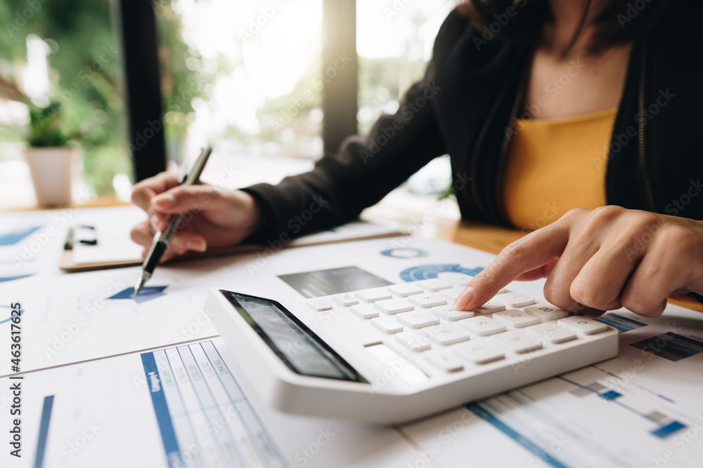 Close up of accountant or banker checking investment results, calculates financial savings, calculates annual taxes and economic concepts. Financial calculation concept. Close up of accountant or banker checking investment results, calculates financial savings, calculates annual taxes and economic concepts. Financial calculation concept.
