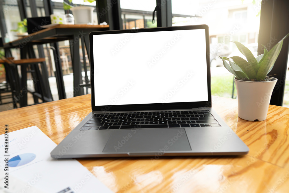 Fototapeta premium laptop on table with blank screen for mock up, clipping path in side.