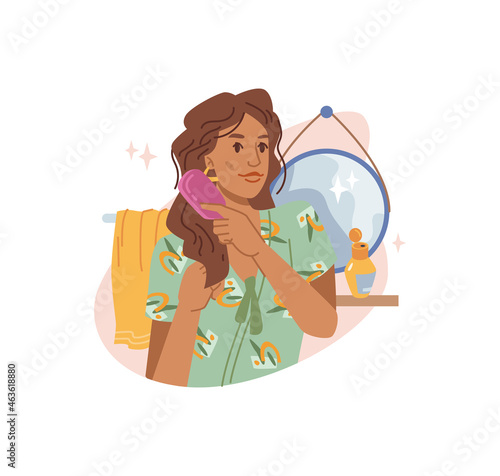 Young brown-haired woman combing her long curly hair with comb at home, mirror and towel on background. Vector haircare procedure, lady brushing hair with haircomb, flat cartoon illustration