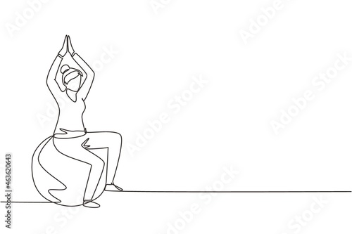 Single continuous line drawing physiotherapy rehabilitation isometric composition with female patient sitting on top of rubber ball with lifting both her hands. One line draw graphic design vector