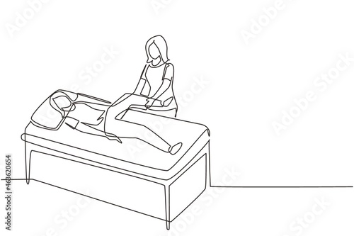 Single continuous line drawing woman lying on massage table professional masseur therapist doing healing treatment massaging patient treating knee manual physical therapy. One line draw design vector