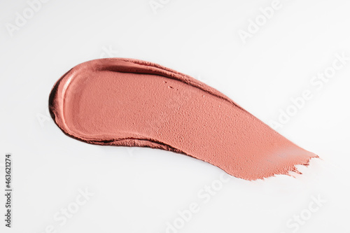 The texture of cream blush on a white background.