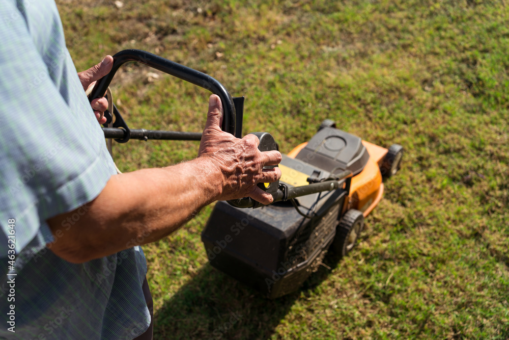 Man mowing lawn in summer Man mowing lawn in summer