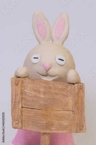 Clay bunny with signboard. Narrow eyes