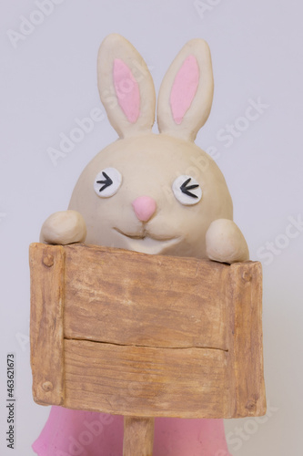 Clay bunny with signboard. Closed eyes