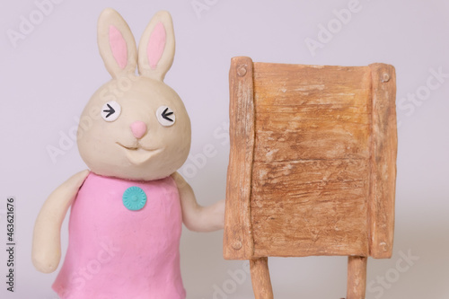 Clay bunny with signboard. Closed eyes
