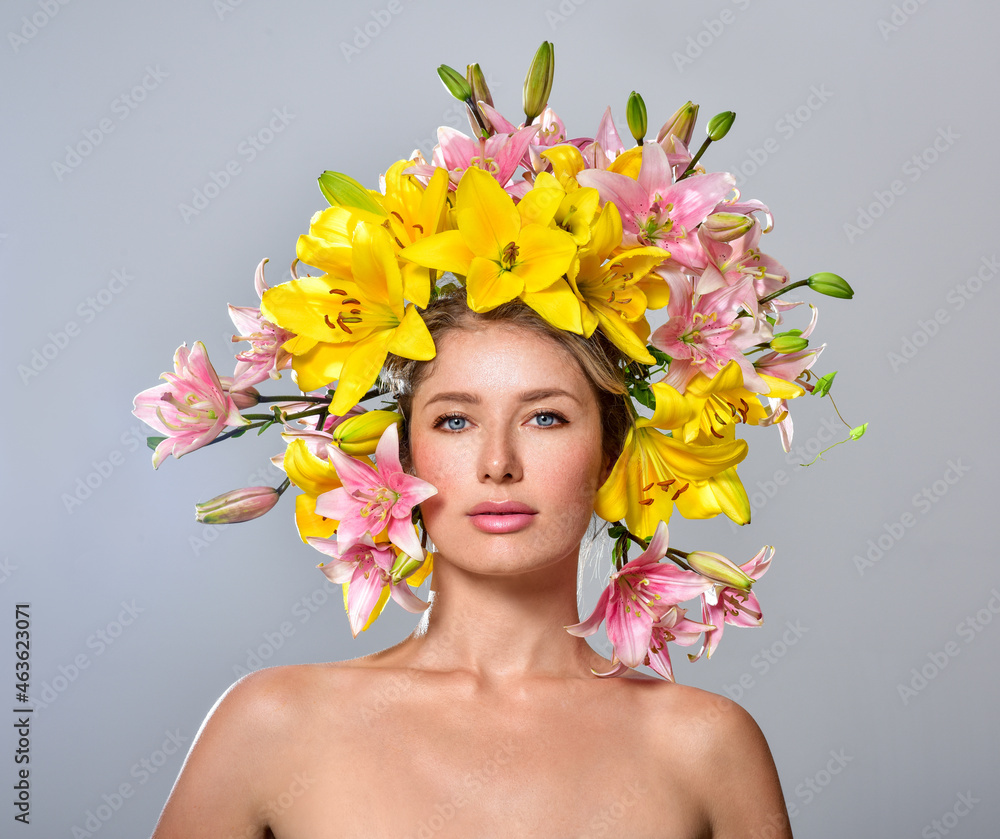 Beautiful woman with flowers in her hair. Bouquet of Beautiful Flowers. Hairstyle with flowers. Nature Hairstyle. Multicolored lilies