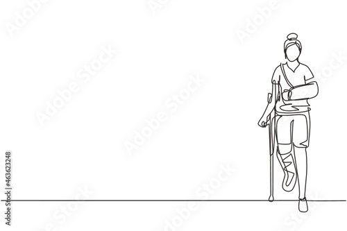 Single continuous line drawing injured woman having head bandage, broken ankle, wrist cast walking with crutch, and medical plaster on leg and arm. One line draw graphic design vector illustration