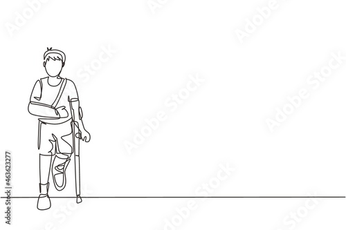 Single continuous line drawing sad injured boy with broken arm and leg in gypsum. Full length of upset injured little boy standing on crutches. Dynamic one line draw graphic design vector illustration