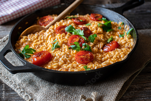 italian risotto with tomatoes and parmesan cheese photo