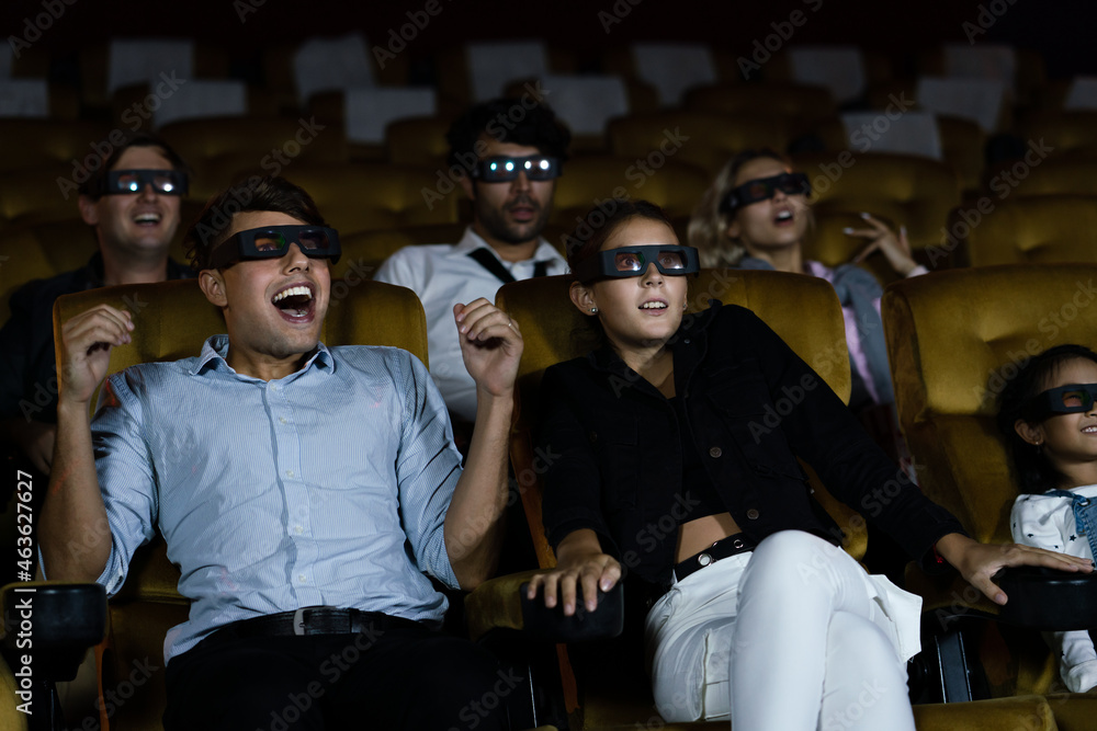 Young couple wear 3D glasses feeling exciting while watching horror movie at cinema