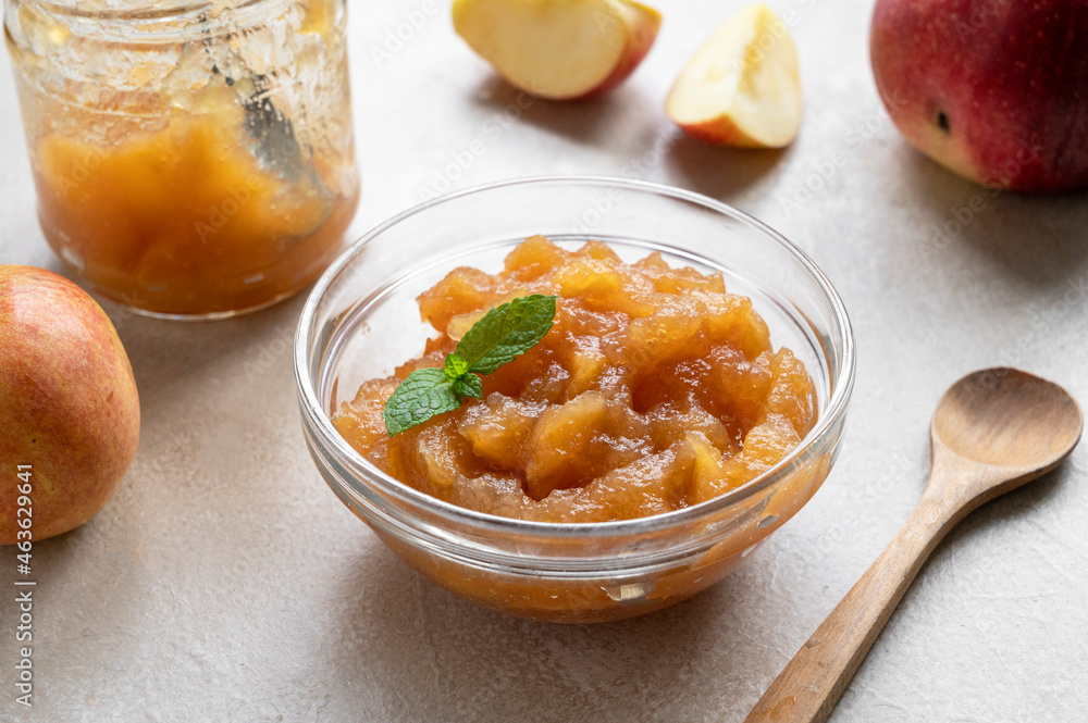 Homemade delicious fruit jam in glass bowl, made from red fresh apples. Homemade delicious fruit jam in glass bowl, made from red fresh apples.
