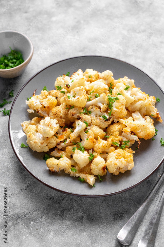 Vegetarian healthy food. Cauliflower baked with cheese, olive oil and parsley. Vegetarian healthy food. Cauliflower baked with cheese, olive oil and parsley.