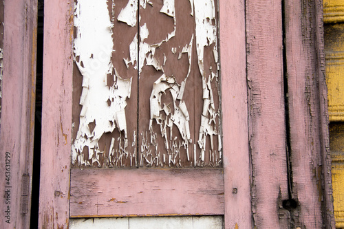 Wooden architecture of Siberia, old Windows with wooden carved architraves. old peeling paint on the wooden Windows